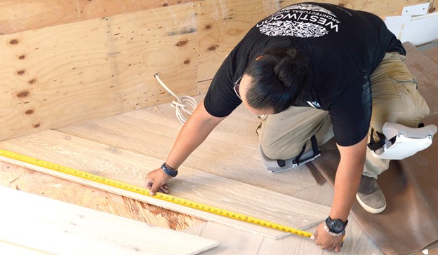 Why-In-House-Install-worker-measuring-floor-plank